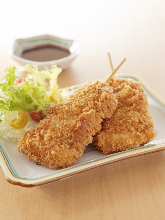 Deep-fried fillet cutlet served over rice in a lacquered box